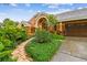 Inviting home showcasing a brick path, mature landscaping, and an attached garage at 3308 Landing Pl, Palm Harbor, FL 34684