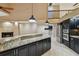 Kitchen with granite countertops, stainless steel appliances, and an open view to the living area at 3308 Landing Pl, Palm Harbor, FL 34684