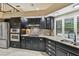 Kitchen with stainless steel appliances, granite countertops, and dark cabinetry at 3308 Landing Pl, Palm Harbor, FL 34684