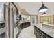 Modern kitchen featuring stainless steel appliances, granite countertops, and a center island at 3308 Landing Pl, Palm Harbor, FL 34684