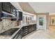 Kitchen featuring granite countertops, dark cabinetry, and stainless steel appliances at 3308 Landing Pl, Palm Harbor, FL 34684