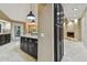 Modern kitchen with granite countertops, dark cabinetry, and stainless steel appliances at 3308 Landing Pl, Palm Harbor, FL 34684