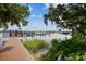 Scenic lakefront view from the dock, showcasing serene water and lush greenery at 3308 Landing Pl, Palm Harbor, FL 34684