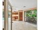 Lanai featuring tile floor, a bar, wood cabinets and a view of the backyard at 3308 Landing Pl, Palm Harbor, FL 34684