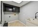 Practical laundry room equipped with cabinets, a utility sink, and convenient hookups for laundry appliances at 3308 Landing Pl, Palm Harbor, FL 34684