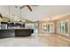Spacious living area with travertine floors, breakfast bar, and plantation shutters at 3308 Landing Pl, Palm Harbor, FL 34684