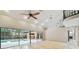 Bright living room featuring travertine floors, high ceilings and sliding glass doors to the pool at 3308 Landing Pl, Palm Harbor, FL 34684