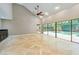 Spacious living room with high ceilings, travertine floors, and views of the pool area at 3308 Landing Pl, Palm Harbor, FL 34684