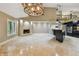 Open-concept living space with a fireplace, kitchen with island, and staircase to second floor at 3308 Landing Pl, Palm Harbor, FL 34684