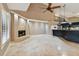 Open-concept living space with fireplace and modern kitchen, featuring a large island at 3308 Landing Pl, Palm Harbor, FL 34684