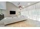 Spacious living room featuring high ceilings, a large sectional sofa, and sliding glass doors to the pool at 3308 Landing Pl, Palm Harbor, FL 34684