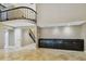 Spacious living room with beautiful tile flooring, dark cabinets, and a staircase leading to the second floor at 3308 Landing Pl, Palm Harbor, FL 34684