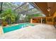 Enclosed screened pool with spa, outdoor bar and ample patio space for entertaining at 3308 Landing Pl, Palm Harbor, FL 34684
