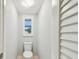 Bright powder room with a toilet and window with plantation shutters at 3308 Landing Pl, Palm Harbor, FL 34684