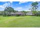 Lush green backyard featuring an enclosed patio, perfect for outdoor relaxation at 3519 Old Course Ln, Valrico, FL 33596