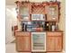 Elegant wet bar with wine rack, beverage fridge, and stylish cabinetry at 3519 Old Course Ln, Valrico, FL 33596