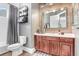 Bathroom with a wood accent wall, updated vanity, and a shower/tub combo at 3519 Old Course Ln, Valrico, FL 33596