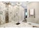 Modern bathroom featuring a glass walk-in shower with a rainfall showerhead and marble tile at 3519 Old Course Ln, Valrico, FL 33596