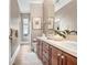Bathroom with double sink vanity, large mirror, and neutral color scheme at 3519 Old Course Ln, Valrico, FL 33596