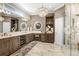Elegant bathroom featuring double sinks, a chandelier, and a glass walk-in shower at 3519 Old Course Ln, Valrico, FL 33596