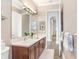 Bathroom with double sink vanity, large mirror, and neutral color scheme at 3519 Old Course Ln, Valrico, FL 33596