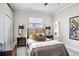 Bedroom with neutral colors, dark furniture, a ceiling fan, and two side mirrors at 3519 Old Course Ln, Valrico, FL 33596