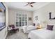 Bedroom with twin beds, a ceiling fan, and plantation shutters on the window at 3519 Old Course Ln, Valrico, FL 33596