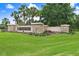 Well-maintained River Hills entrance with stone accents, fresh landscaping, and American flags at 3519 Old Course Ln, Valrico, FL 33596