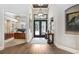 Welcoming foyer boasting hardwood floors, stylish lighting, and an open view into the study at 3519 Old Course Ln, Valrico, FL 33596