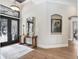Inviting foyer featuring hardwood floors, decorative mirrors, and a view of the elegant front doors at 3519 Old Course Ln, Valrico, FL 33596