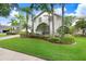 Beautifully landscaped front yard with palm trees and well-manicured lawn at 3519 Old Course Ln, Valrico, FL 33596