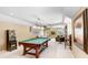 Spacious game room with pool table, bar area, and ample seating at 3519 Old Course Ln, Valrico, FL 33596