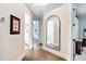 Hallway with hardwood floors and an arched mirror leading to a bedroom at 3519 Old Course Ln, Valrico, FL 33596