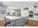 Bright eat-in kitchen features a center island with sink, white cabinets and stainless steel appliances at 3519 Old Course Ln, Valrico, FL 33596