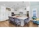 A bright kitchen featuring a large center island, stainless steel appliances and hardwood floors at 3519 Old Course Ln, Valrico, FL 33596