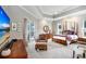 A spacious main bedroom with a sitting area, ceiling fan, and access to the backyard at 3519 Old Course Ln, Valrico, FL 33596