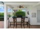 Outdoor kitchen features a built-in grill, counter seating, and stylish decor, perfect for entertaining at 3519 Old Course Ln, Valrico, FL 33596