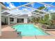 Inviting pool and patio area featuring ample seating and lush landscaping, perfect for outdoor enjoyment at 3519 Old Course Ln, Valrico, FL 33596