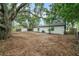 Large yard with mature trees, privacy fencing, and a storage shed in the backyard at 3812 W Rogers Ave, Tampa, FL 33611