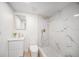 Modern bathroom with a glass-enclosed shower, a stylish vanity, and marble-look tiles at 3812 W Rogers Ave, Tampa, FL 33611