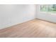 Well-lit bedroom with wood-look floors and a large window offering neighborhood views at 3812 W Rogers Ave, Tampa, FL 33611