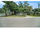 Charming single-story home with large shade trees in the front yard at 3812 W Rogers Ave, Tampa, FL 33611