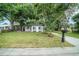 Charming home with a well-maintained lawn, mature trees, and long driveway at 3812 W Rogers Ave, Tampa, FL 33611