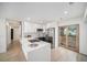 Contemporary kitchen featuring white cabinets, stainless steel appliances, and a stylish backsplash at 3812 W Rogers Ave, Tampa, FL 33611