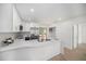 Modern kitchen showcasing white countertops, a stainless steel refrigerator, and ample cabinet space at 3812 W Rogers Ave, Tampa, FL 33611