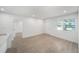 Bright living room with wood floors, natural light, and fresh neutral paint throughout at 3812 W Rogers Ave, Tampa, FL 33611
