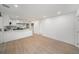 Open floor plan featuring a modern kitchen and bright living space with sleek flooring at 3812 W Rogers Ave, Tampa, FL 33611