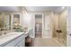 Bright bathroom features double vanity, walk-in shower, and access to the walk-in closet at 3869 Consolare Ct, Wesley Chapel, FL 33543