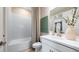 White bathroom vanity with shower and tub combination with tiled walls at 3869 Consolare Ct, Wesley Chapel, FL 33543