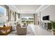 Spacious living room with tile floors, recessed lighting, and large sliding glass doors at 3869 Consolare Ct, Wesley Chapel, FL 33543